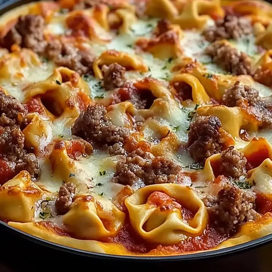 A pizza with meat and cheese on top.
