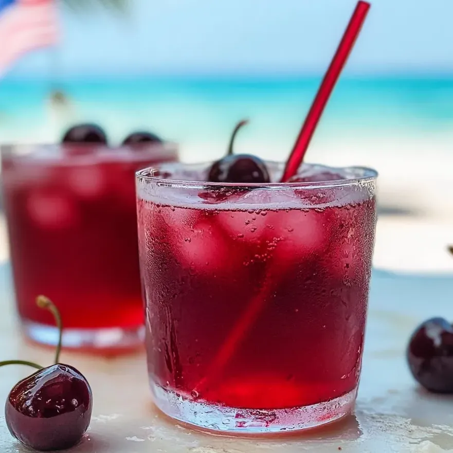 A glass of cherry vanilla fizzy drink.