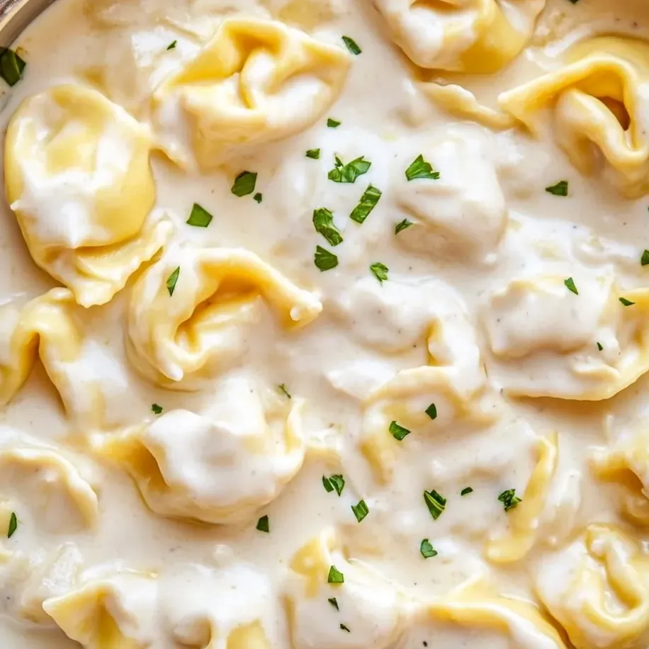 A bowl of garlic Parmesan tortellini pasta.