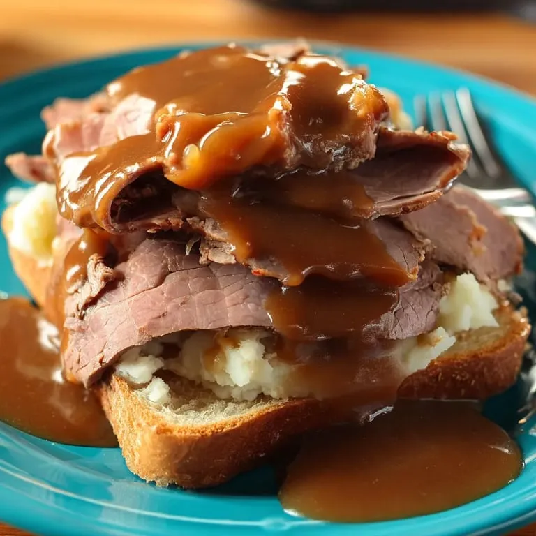 A plate of meat with gravy on it.