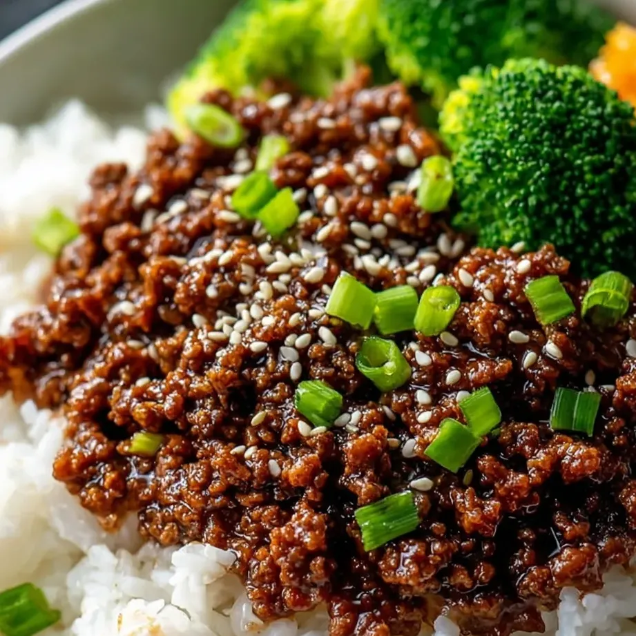A plate of food with rice, broccoli, and beef.