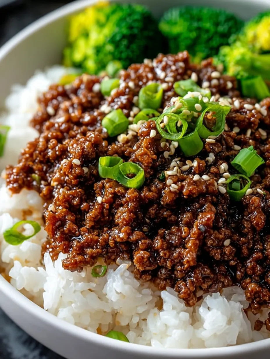 A bowl of food with rice and meat.