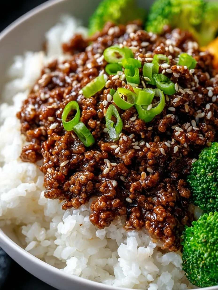 A bowl of food with rice and meat.