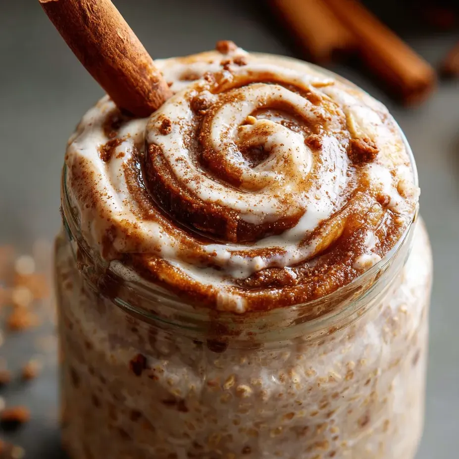 A glass jar filled with a creamy dessert.