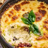 A close up of a Tuscan cheese dip with vegetables.
