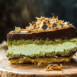 A slice of chocolate cheesecake with a topping of nuts.