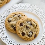Two almond flour chocolate chip cookies on a white plate.
