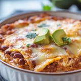 A plate of bean and cheese enchiladas.