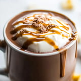 A cup of chocolate with whipped cream.