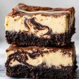 A slice of chocolate cake with a swirl of chocolate and vanilla.