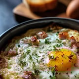 A fried egg with bacon and herbs.