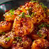 A bowl of shrimp with spices.