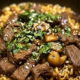 A bowl of beef and mushrooms.