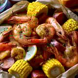 A plate of shrimp and corn.