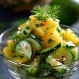 A bowl of food with a green topping.