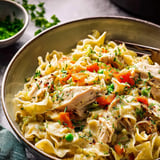 A bowl of pasta with chicken and vegetables.