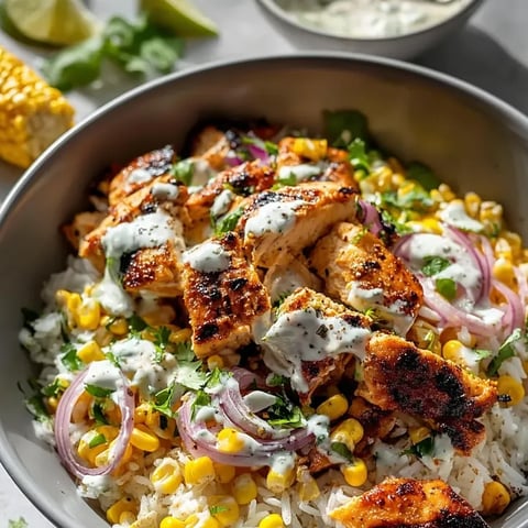A bowl of food with chicken, corn, and onions.